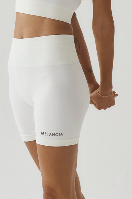 Cream seamless gym shorts with brown metanoia logo